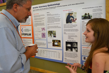 Kristin Campbell discuss her river otter project with I-STEM Associate Director Bob Coverdill.